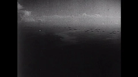 Para-troopers jump from their planes to commence D-Day during the 1940s Video stock 101703317