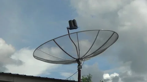 Parabolic tv umbrella with white clouds and blue sky background Stock Footage 199030554