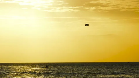 Parachute activity at tropical beach at sunset 動画素材 130246751
