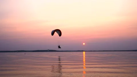 Parachute flight over the sea at sunset Stock Footage 245408509