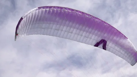 Parachute floating in the air against cloudy sky Stock Footage 76046673