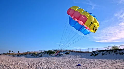 Parachute flying in wind on sand beach Stock Footage 56717441