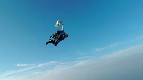 Parachute has opened and a man and woman are sky diving Stock Footage 55334255