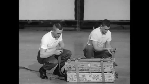 Parachute riggers practice rigging and loading A7 A and A 21 A sling containers Stock Footage 79429543