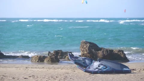 The parachute wing  for the kiteboarding lies on the beach. Stock Footage 153454792