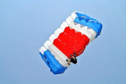Parachuter with blue white red parachute Stock Photos
