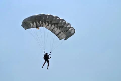 Parachuter with grey parachute skydiving Stock Photos