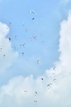 Parachuters in the air with clouds in background Stock Photos