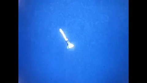 Parachutes deploy and a space capsule descends onto White Sands Missile Range in Stock Footage 93508510