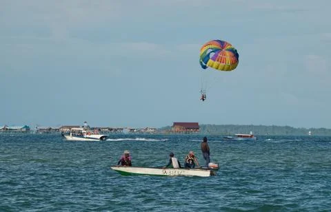 Parachuting behind the boat Stock Photos