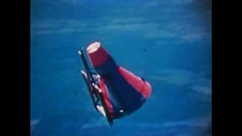 A parachuting space capsule is shown as well as rocket liftoffs during Project Stockbeeldmateriaal 94006714