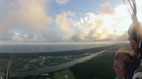 Parachuting View of Ocean, Landscape , And Cloudy Sunset Stock Footage 24676131