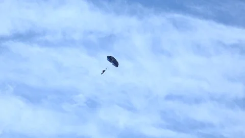 Parachutist coming down from the clouds 4K Stock Footage 82441791