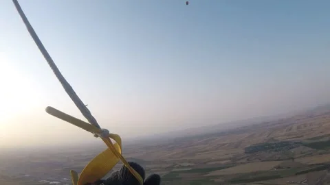 The parachutist controls his flight using parachute straps. Point of View. Stockbeeldmateriaal 314392807