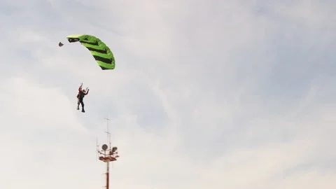 The Parachutist Flying and Lands on the Ground in the Field, Extreme Sport Stock Footage 155449953