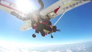 Parachutist jumping in tandem out of an sport airplane Stock Footage