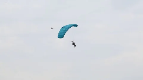 The parachutist jumps along with the instructor. Stock Footage 81185234