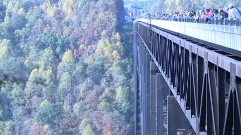 Parachutist jumps while crowd watches during annual Bridge Day in Fayetteville Stock Footage 86476987