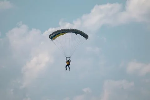 Parachutist Soaring Through Cloudy Sky Photos