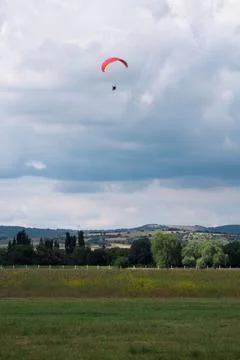 Parachutists approaching ground at cloudy sky Fotos Stock