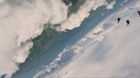Parachutists crossing through a big cloud in free fall-SKY DIVING Video stock 259028019