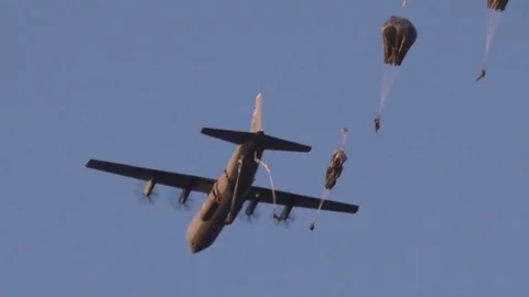 Parachutists dropping out of C-130 Hercules Stock Footage 84883927