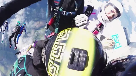 Parachutists holding hands in sky. Skydiving. Flight in blue sky. Teamwork Video stock 70531890