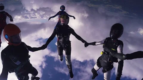 Parachutists make formation in sky. Holding hands in air. Clouds in blue sky Video stock 64240046