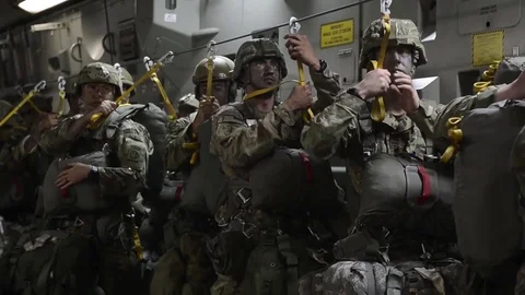 Parachutists ready to perform static line jump from C-17 Stock Footage 90939400