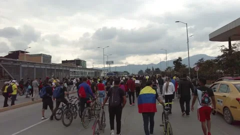 Parade of colombian protesters with flags against Ivan duque tax reform policies Stock Footage 153329232