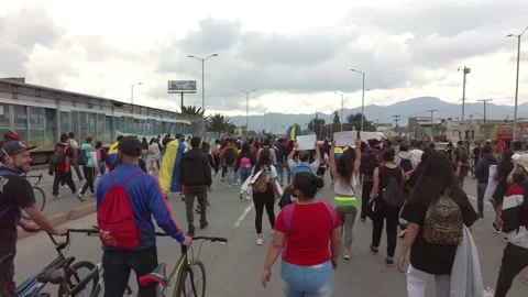 Parade of colombian protesters with flags against Ivan duque tax reform policies Stock Footage 153329248