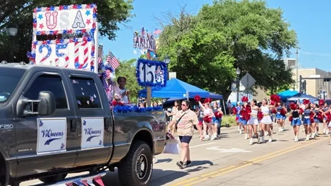 Parade float and cheerleaders marching in street procession 動画素材 340941792