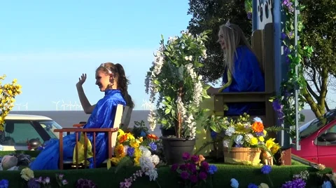 A Parade Float Drives Along the Road as Girls Waves to the Crowd Stock Footage 62639872
