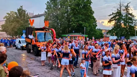 Parade Float With Marching Participants During City Festival in the Evening Stock Footage 318061783