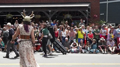 Parade participants marching with brass instruments and pole dancing on stree Stock Footage 339036405