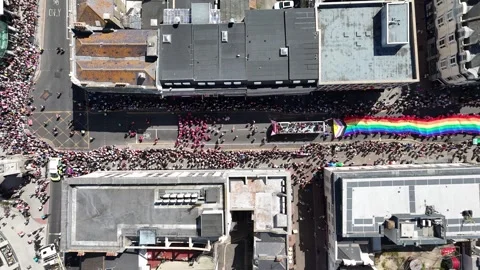 Parade participants, rainbow flags and vibrant floats fill the streets during Video stock 341847029