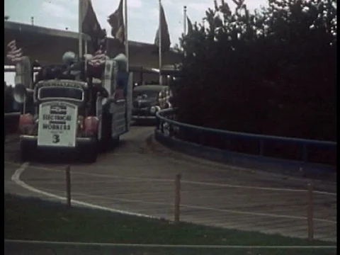 A parade route includes a float for electrical workers, Chinatown dancers, and Stock Footage 75199637