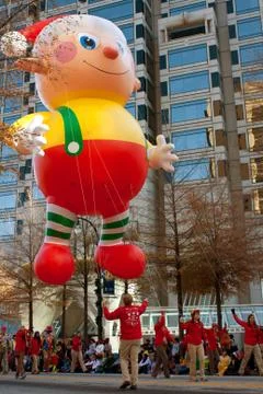 Parade workers guide huge float down atlanta street Stock Photos