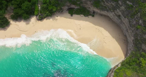 Paradise beach aerial drone view Kelingking cliff Nusa Penida sandy coast Bali Stock Footage 310236817