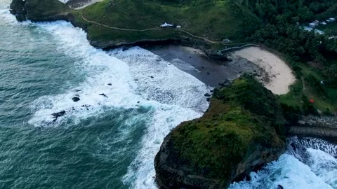 Paradise beach hidden between volcanic rocks on Kasap coast, Java, Stock Footage 166610227
