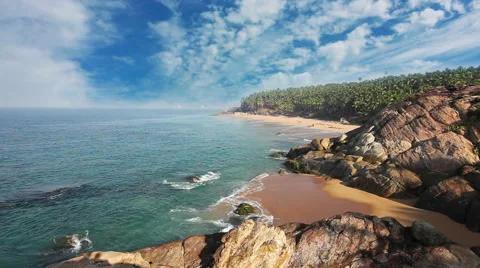 Paradise beach with stones and palm trees, aerial view. Kerala, India Stock Footage