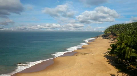 Paradise beach with stones and palm trees, aerial view. Kerala, India Stock Footage