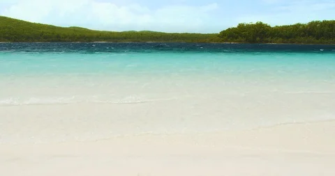 Paradise with clear water waves lapping at beach Vídeos de archivo 128693581