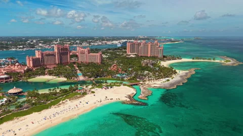 Paradise Island, Bahamas: Aerial view of pink resort towers and turquoise beach Stock Footage 347745858
