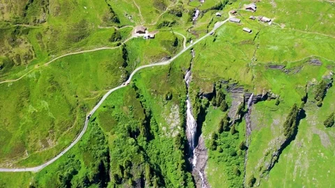 Paradise like Location with a waterfalls among Green Meadows on top of the Alps Stock Footage 246983953
