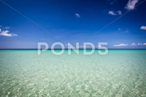 Paradise sand beach on sunny day Stock Photos