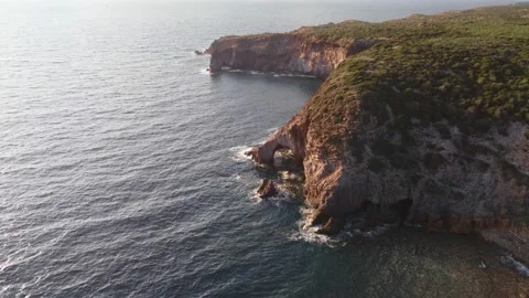 Paradisiac remote cliff coast, with arched cave in South Sardinia, aerial Vídeo Stock 235369615