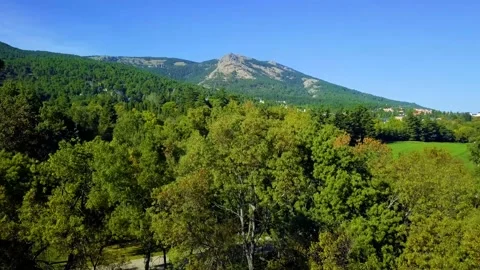 Paradisiacal golf course between mountains and forests. aerial Stock-Footage 168735736