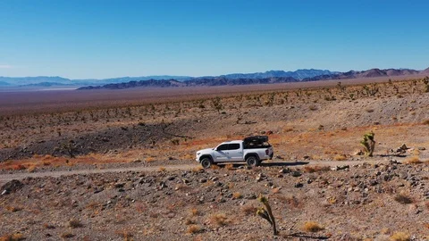 Paradoxically close up but still widely set aerial view of a truck zooming Video stock 124579157