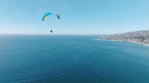 Paraglide Pilot practicing adventurous sport, Aerial coastal views Malibu coast 動画素材 218411816